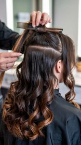 Coiffage en cours : cheveux séparés en sections, boucles en réalisation au salon